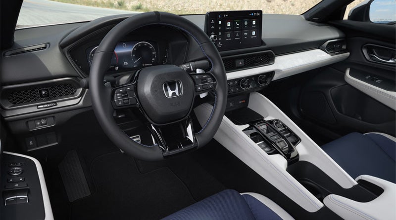 New Honda Prelude Hybrid's driver-centric cockpit features flat-bottom steering wheel and digital instrument cluster.